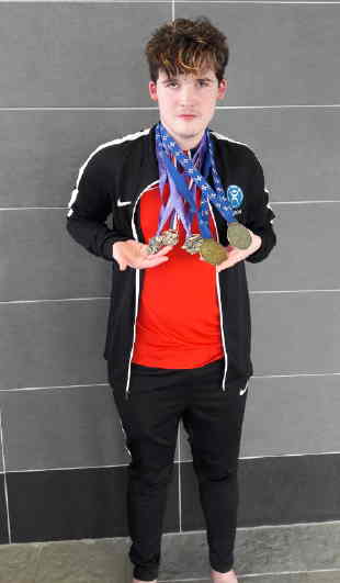 Aaron with swimming medals